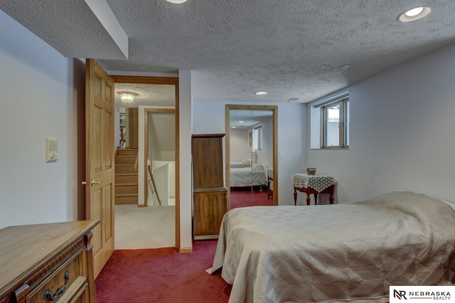 carpeted bedroom with a textured ceiling