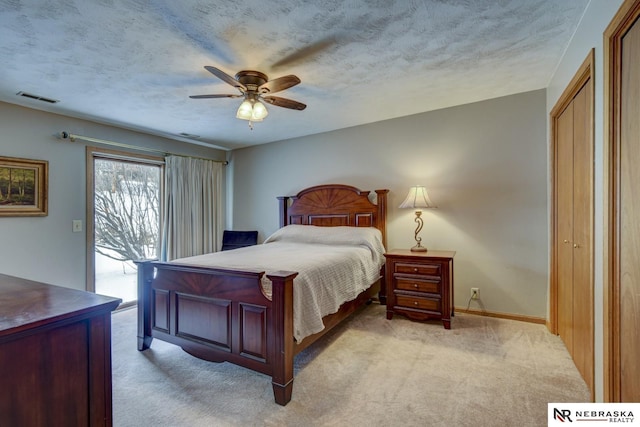 bedroom with access to exterior, light colored carpet, a textured ceiling, and ceiling fan