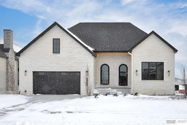 french provincial home with a garage