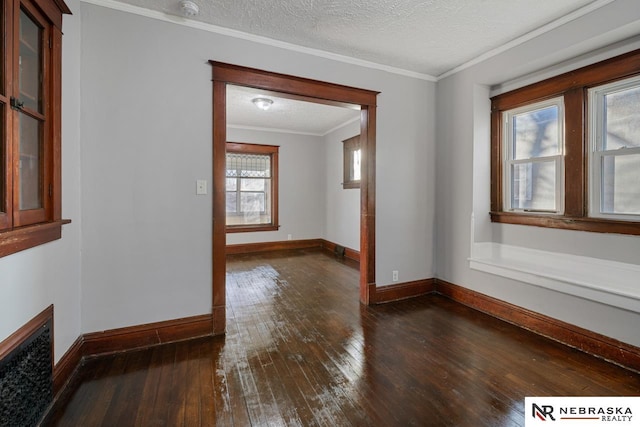 spare room with ornamental molding, a textured ceiling, and dark hardwood / wood-style flooring