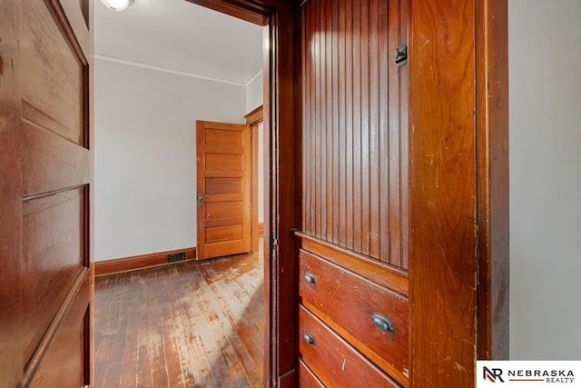 details featuring hardwood / wood-style flooring and ornamental molding