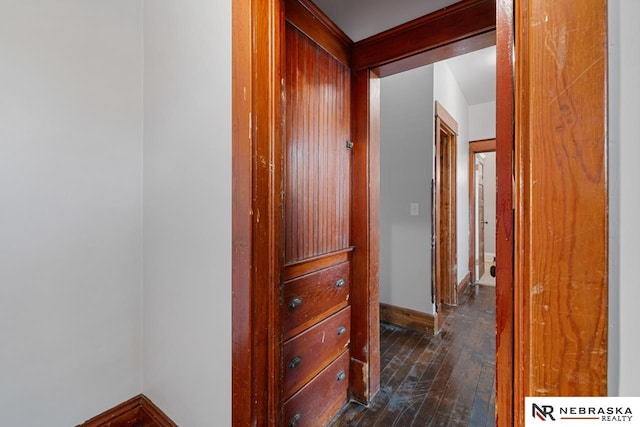 hallway with dark hardwood / wood-style flooring