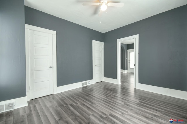 empty room with hardwood / wood-style flooring and ceiling fan