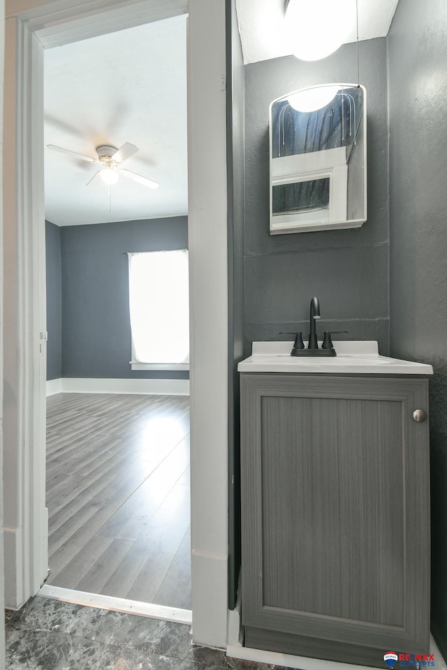 bathroom featuring wood-type flooring, ceiling fan, and vanity