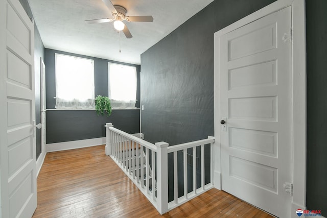 interior space with ceiling fan and wood-type flooring