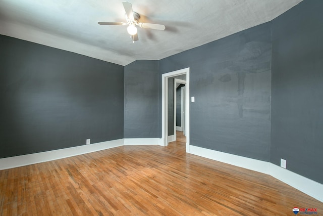 unfurnished room with hardwood / wood-style flooring, ceiling fan, and lofted ceiling