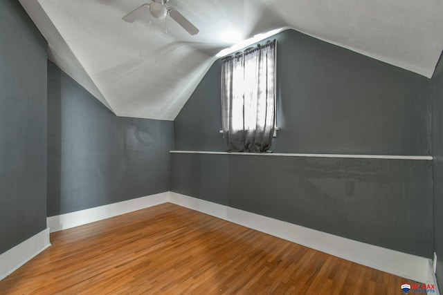 additional living space featuring ceiling fan, vaulted ceiling, and wood-type flooring