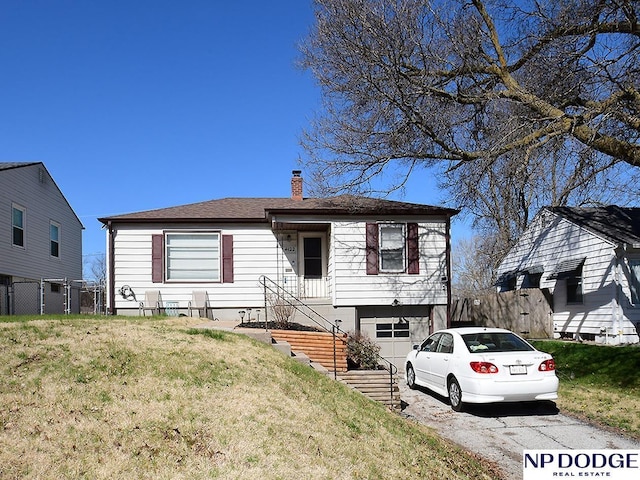 view of front of home with a garage and a front yard