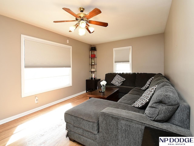 living room featuring hardwood / wood-style floors and ceiling fan