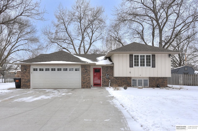 1815 Sherwood Cv, Fremont, NE 68025 - tri-level home with fence, brick siding, a garage, board and batten siding, and concrete driveway