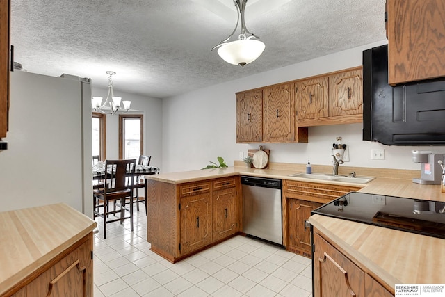 kitchen featuring hanging light fixtures, a textured ceiling, sink, and dishwasher