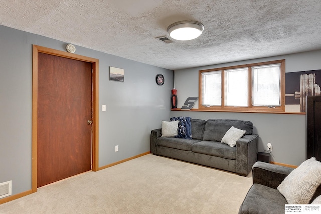 living room with carpet floors and a textured ceiling