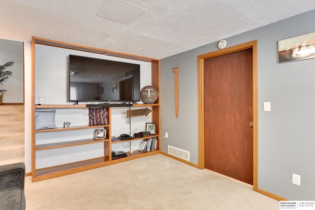 living room with carpet flooring and a textured ceiling