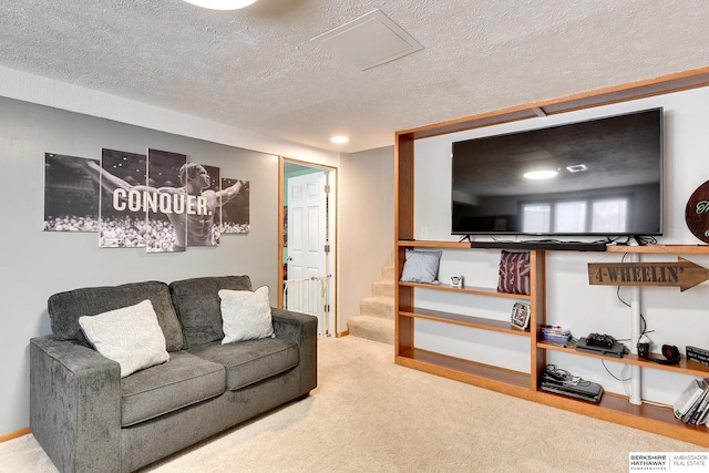 living room featuring carpet and a textured ceiling