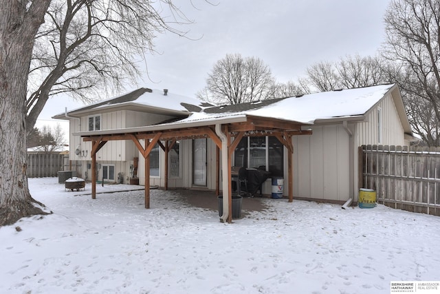 snow covered property featuring central AC