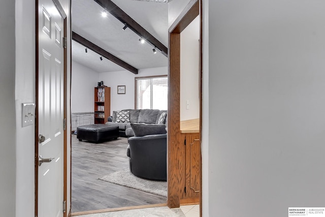 hall featuring beam ceiling and light hardwood / wood-style flooring