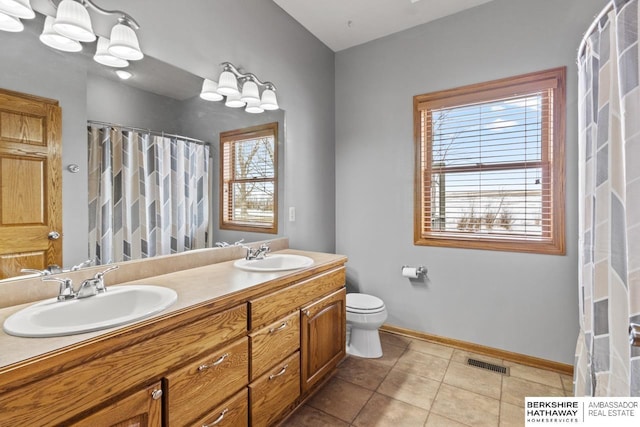 bathroom with vanity, toilet, and tile patterned flooring