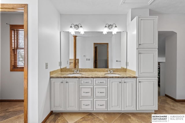 bathroom with vanity and a textured ceiling