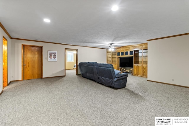 living room with crown molding, carpet floors, and ceiling fan