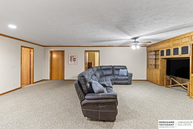 living room with ceiling fan, crown molding, a textured ceiling, and carpet