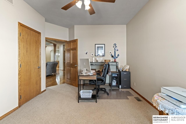 carpeted office featuring ceiling fan