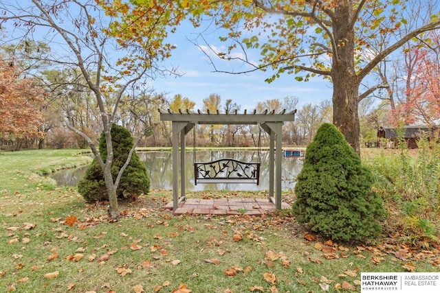 community / neighborhood sign with a yard and a water view