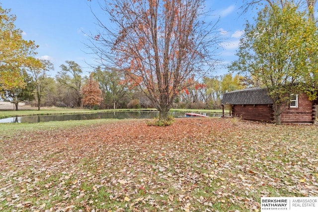 view of yard featuring a storage unit and a water view