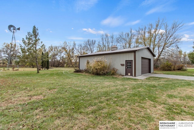 exterior space featuring a garage and a lawn