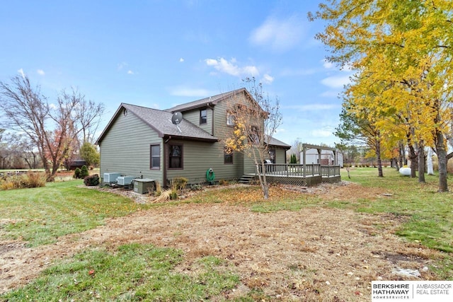 rear view of property with a pergola, a lawn, and a deck