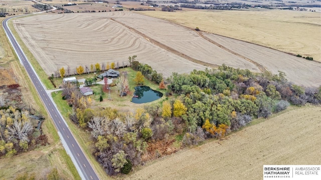 birds eye view of property featuring a water view and a rural view