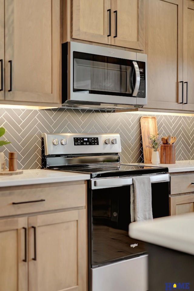 kitchen with stainless steel appliances, decorative backsplash, and light brown cabinets