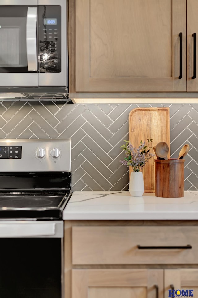 kitchen featuring tasteful backsplash, appliances with stainless steel finishes, and light brown cabinets