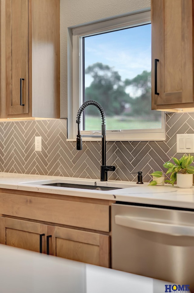 room details featuring tasteful backsplash, dishwasher, and sink