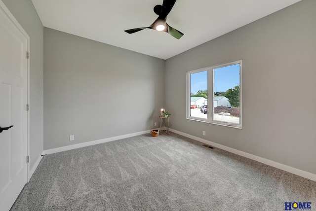 spare room featuring ceiling fan and carpet flooring