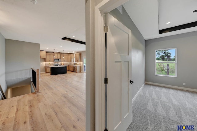 corridor with light colored carpet