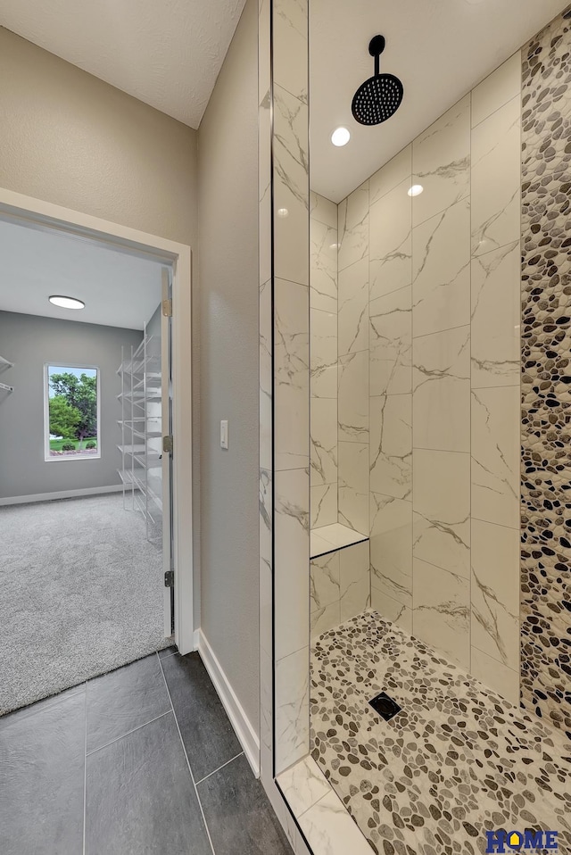 bathroom with a tile shower