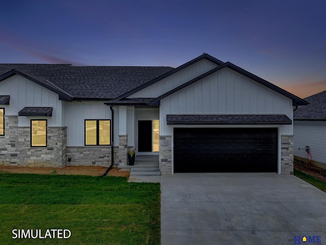 view of front of house with a garage and a yard