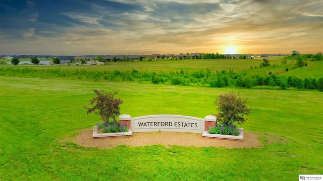 view of community with a rural view and a yard