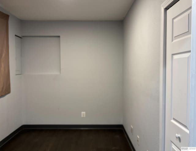 spare room with dark hardwood / wood-style flooring