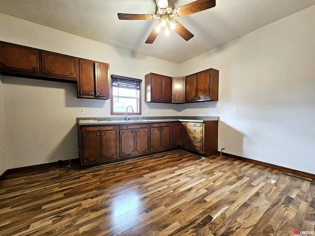 kitchen with dark brown cabinets, dark hardwood / wood-style floors, sink, and ceiling fan