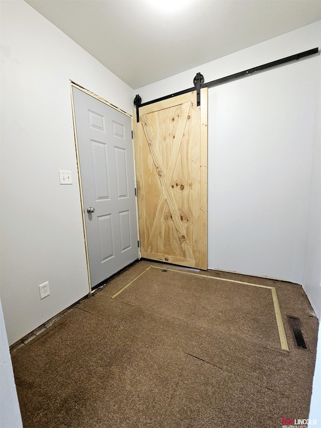 spare room featuring a barn door