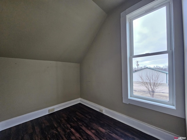 bonus room with wood-type flooring and vaulted ceiling