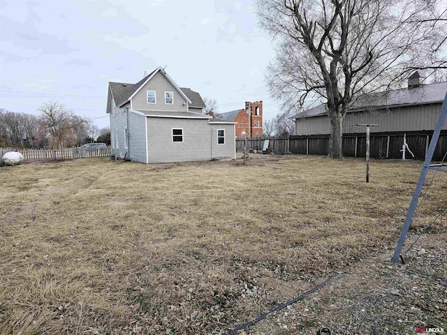 back of house with a lawn