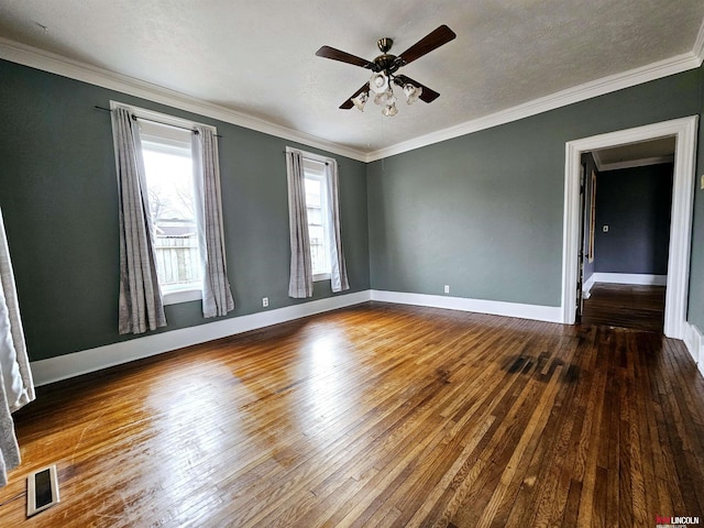 spare room featuring a textured ceiling, ornamental molding, dark hardwood / wood-style floors, and ceiling fan