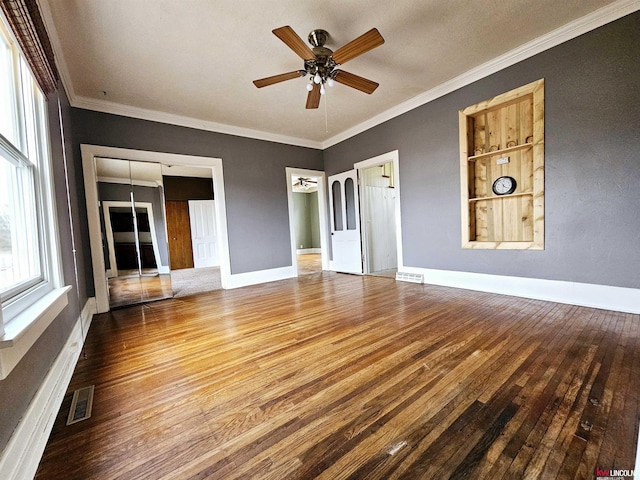 unfurnished living room with crown molding, hardwood / wood-style floors, and ceiling fan