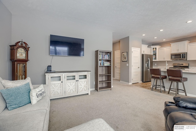 carpeted living room featuring a textured ceiling