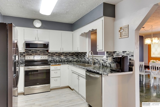 kitchen featuring white cabinetry, stainless steel appliances, backsplash, and sink