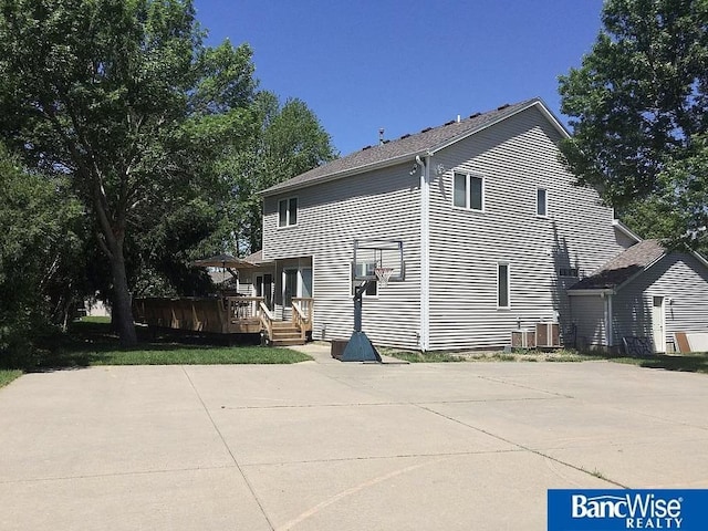 back of property featuring a deck and central air condition unit