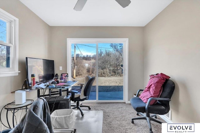 carpeted home office featuring a wealth of natural light and ceiling fan