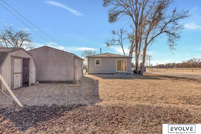 exterior space featuring a lawn and a storage unit